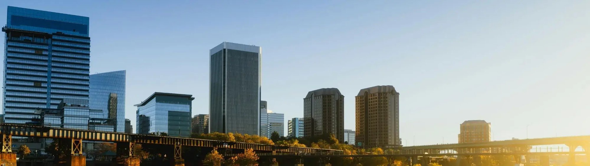 Richmond, Virginia skyline at sunrise, featuring modern office buildings and bridges. Richmond, Virginia skyline at sunrise, featuring modern office buildings and bridges.
